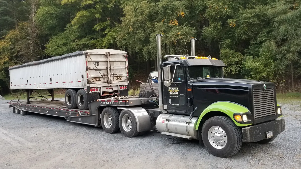 Dunne&rsquo;s lowboy hauling a dump trailer